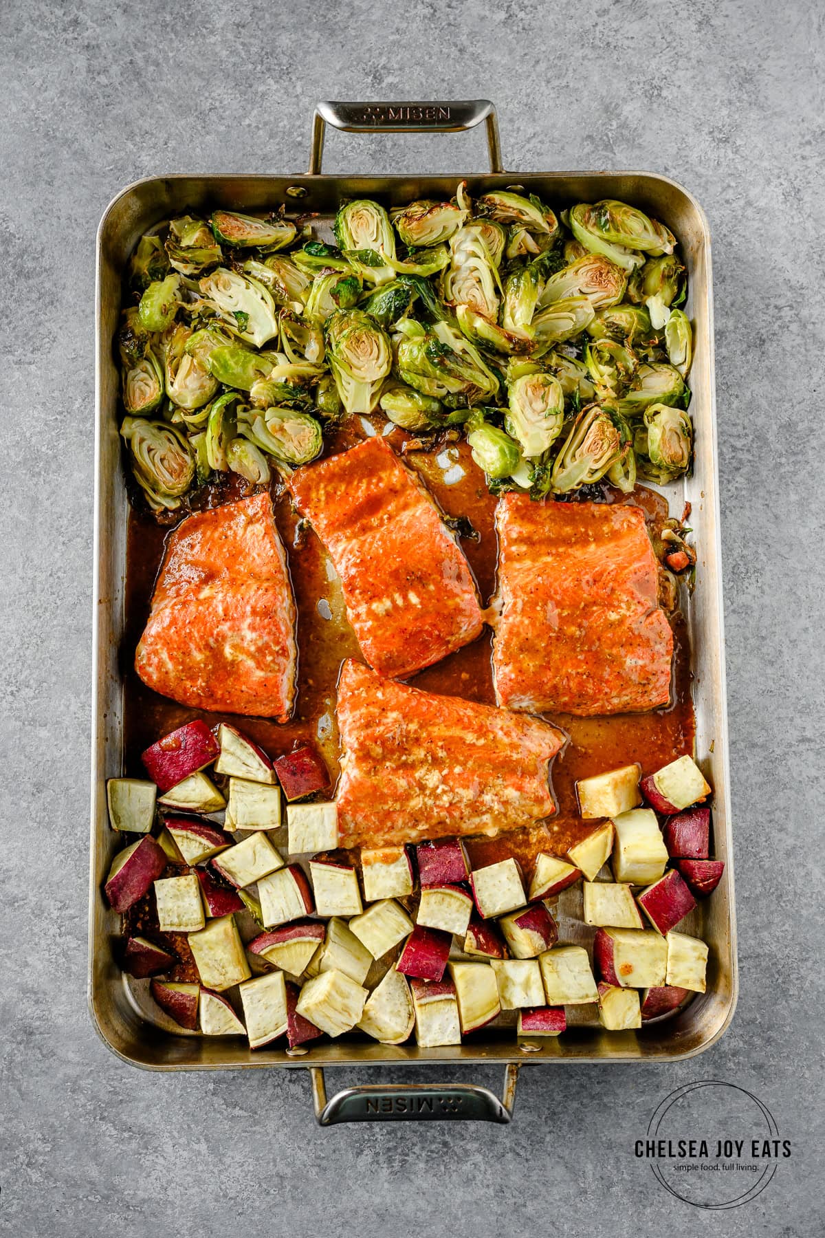 Roasted maple mustard salmon with brussels sprouts and sweet potatoes on a sheet pan.