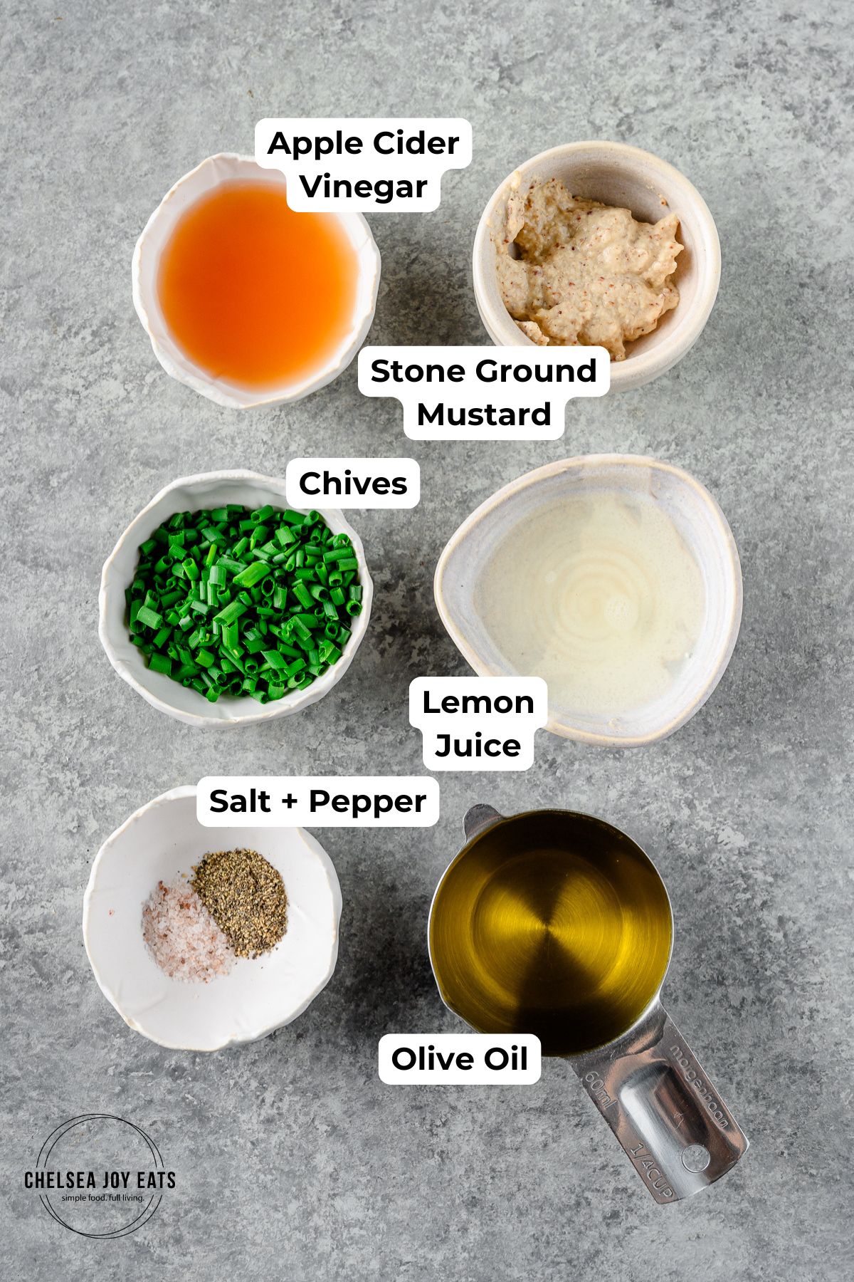 Ingredients for Mustard Chive Vinaigrette in individual cups and bowls with text labels for each ingredient.