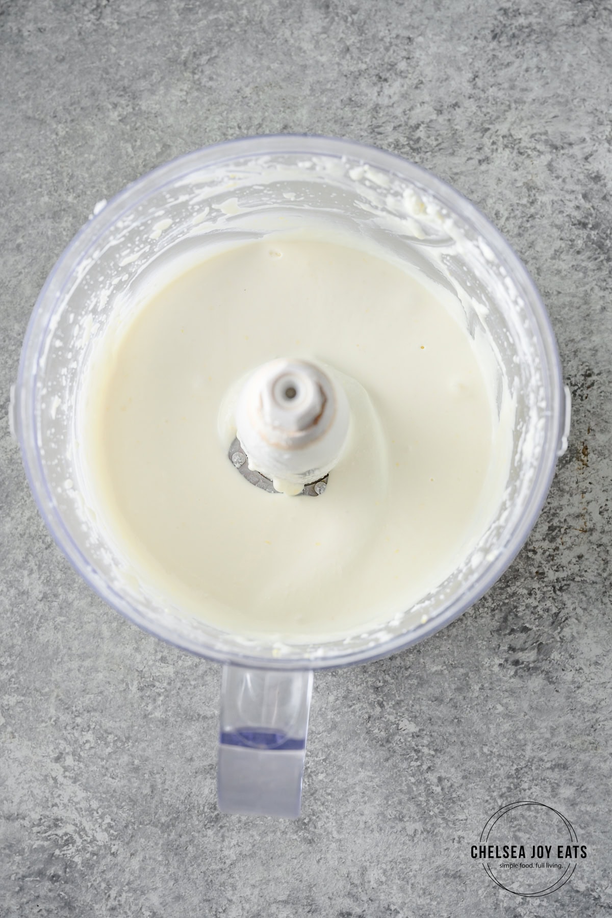 Whipped feta sauce in the bowl of a food processor.