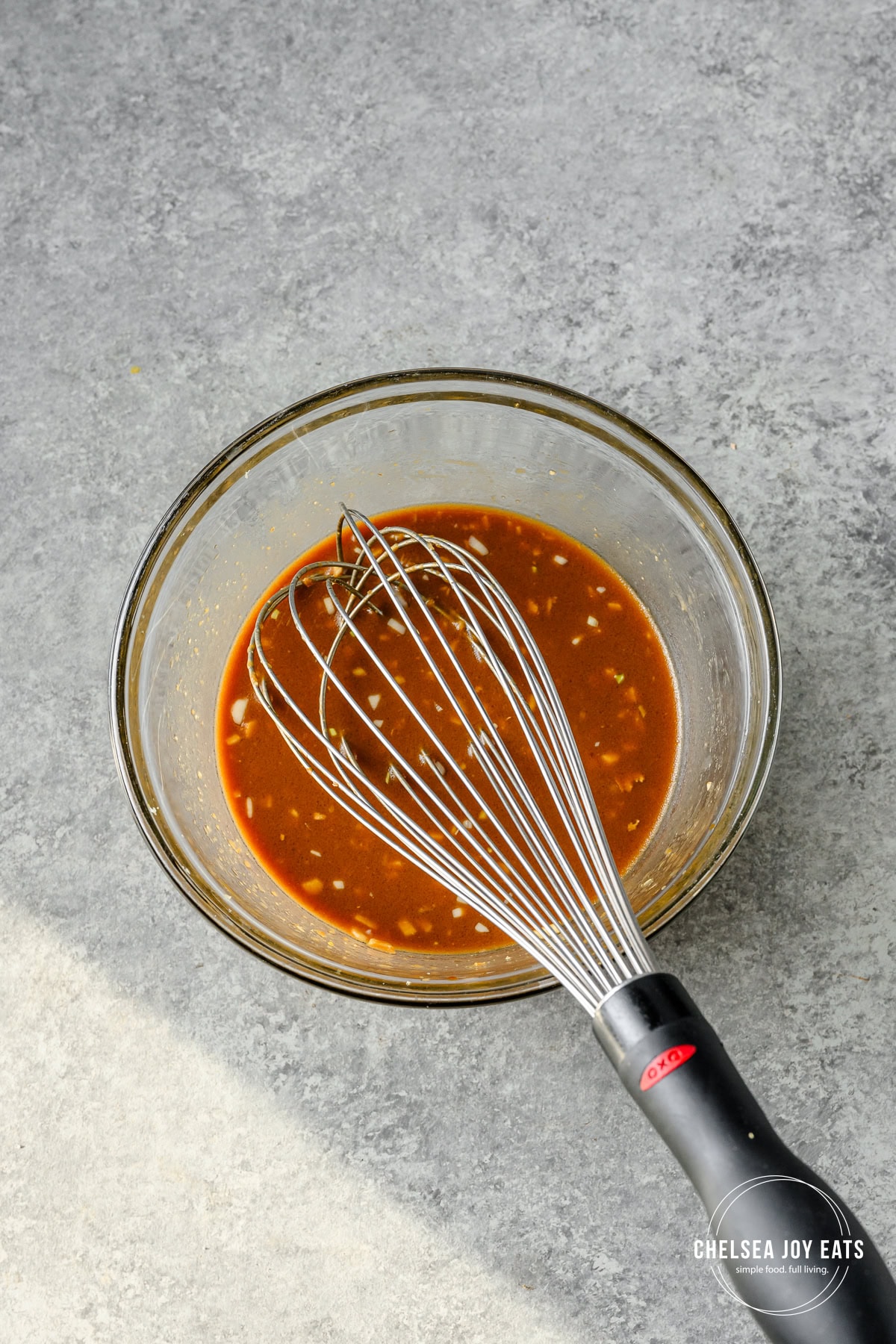 Ginger miso sauce whisked in a small glass bowl.