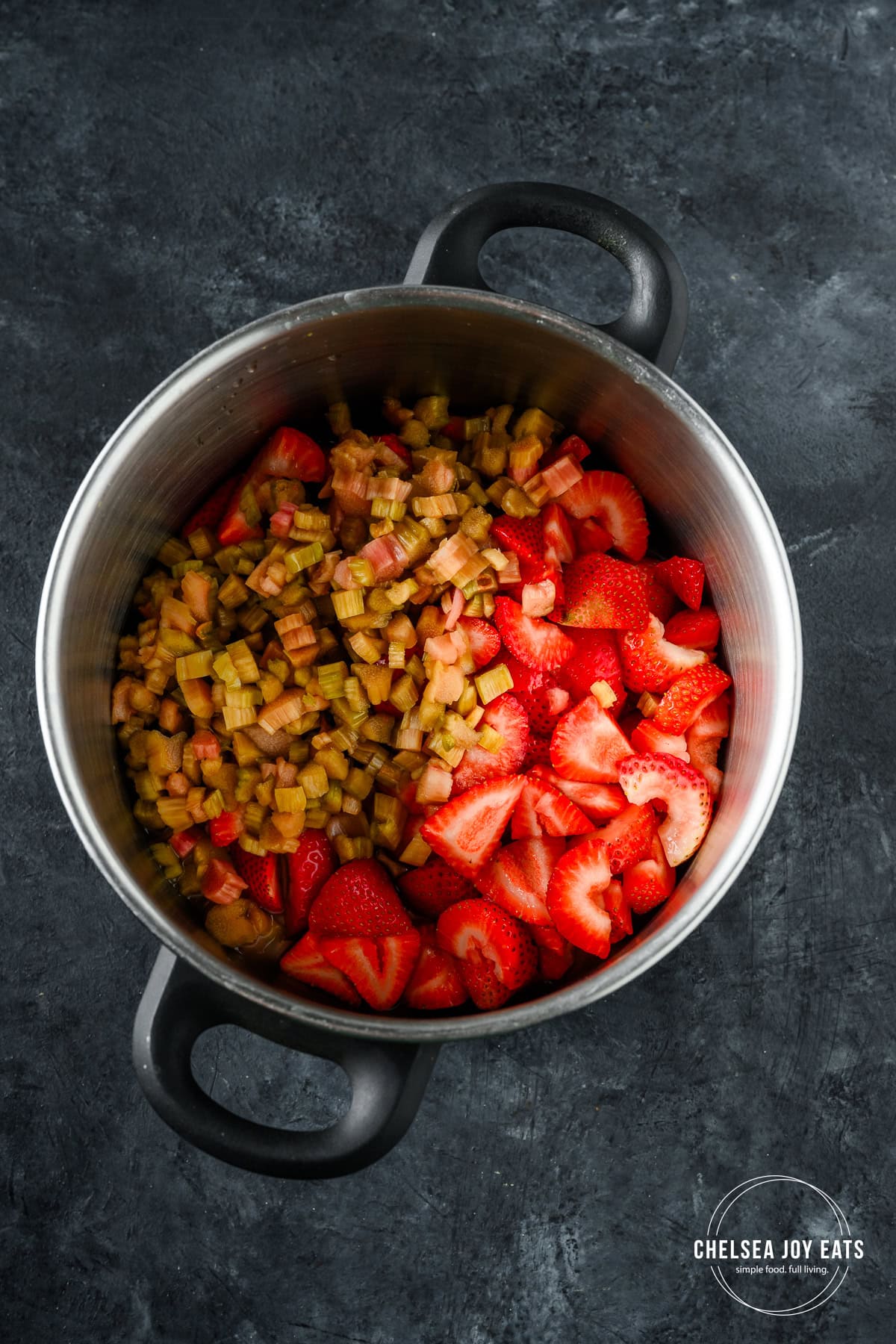 Strawberries and rhubarb in a deep pot.