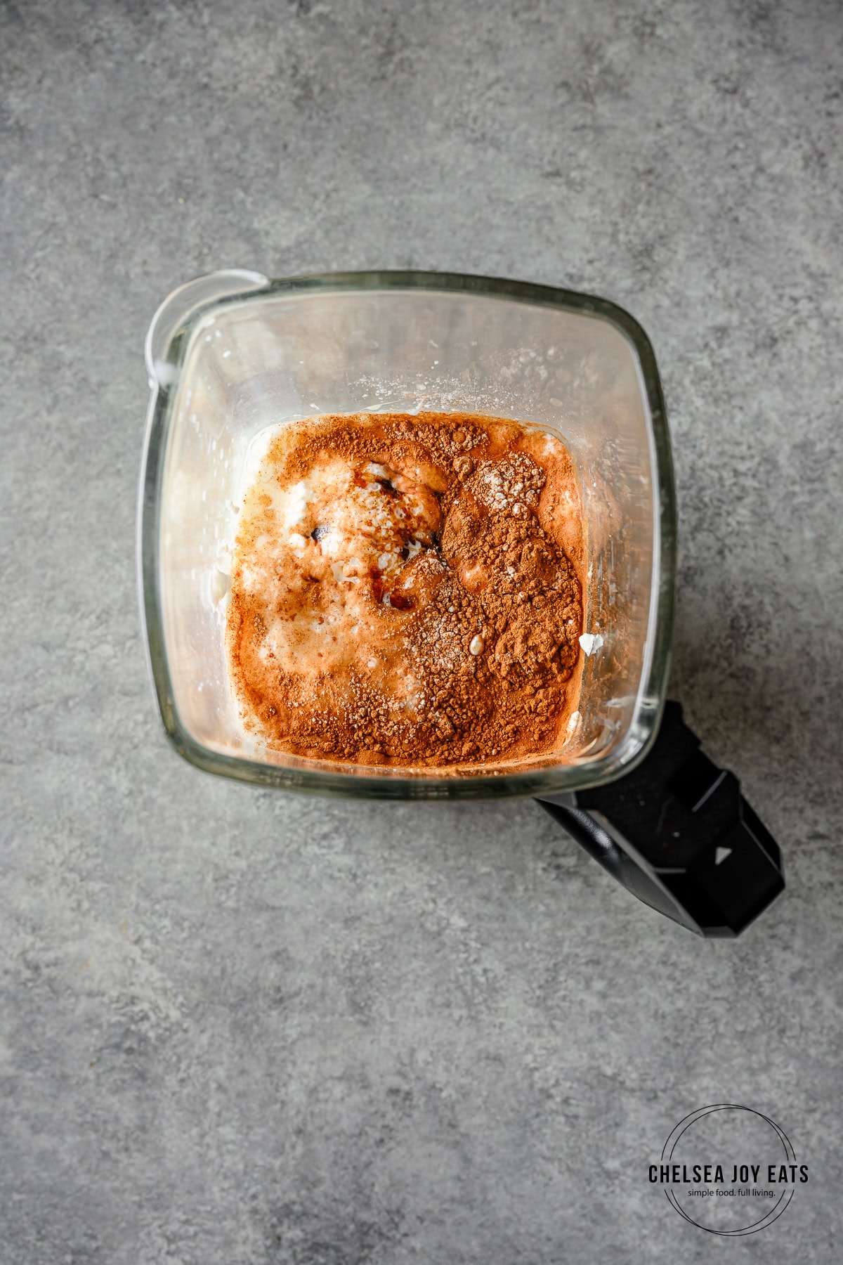 Cottage cheese, eggs, milk, and cinnamon in a blender carafe.