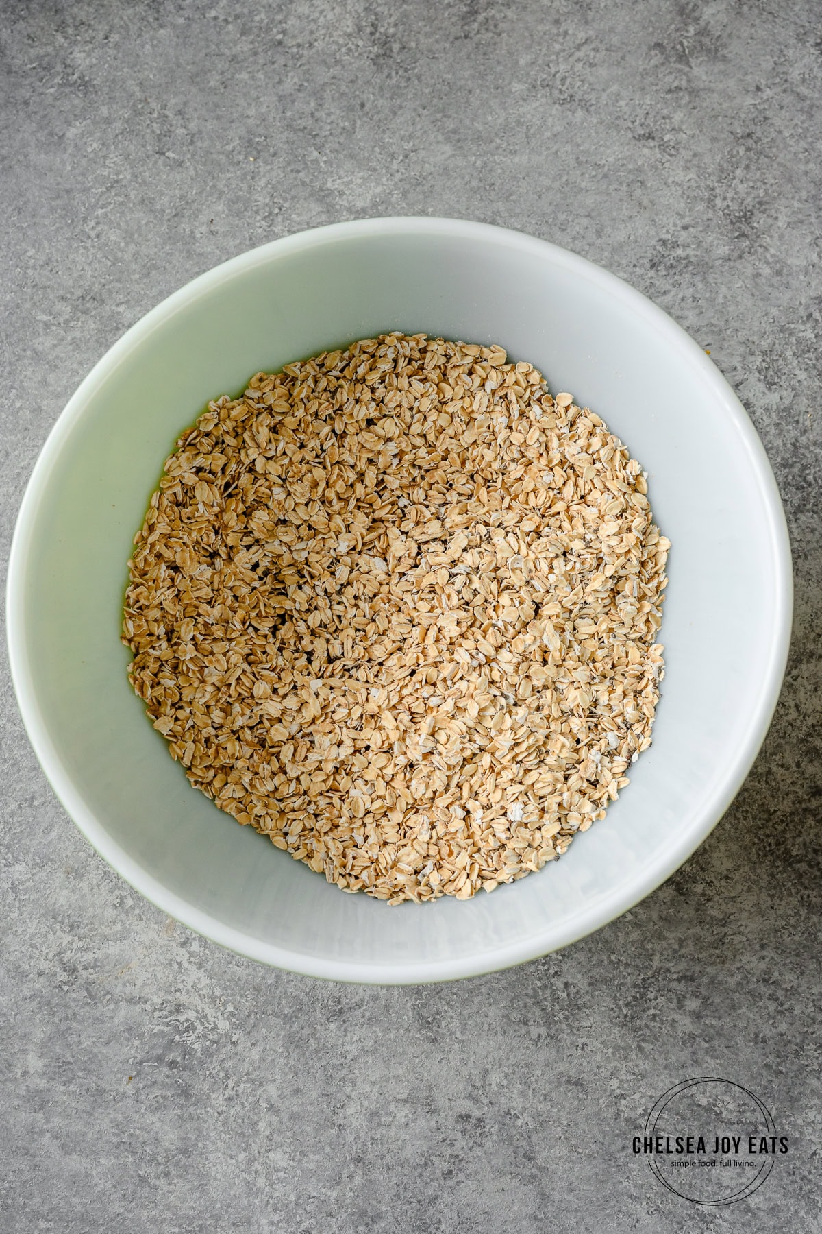 Gluten free rolled oats and chia seeds in a large mixing bowl.