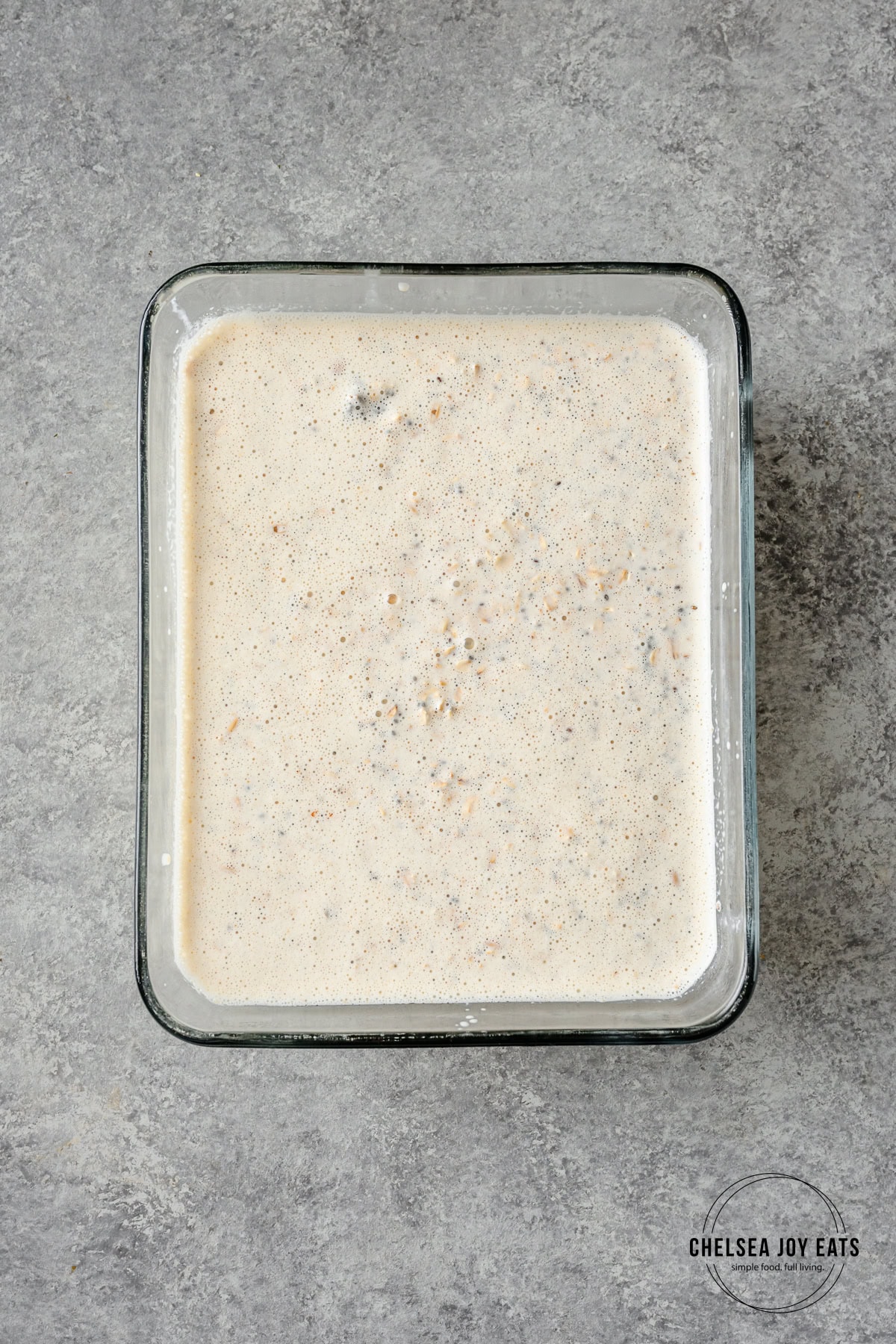 Unbaked cottage cheese oatmeal in a glass dish.