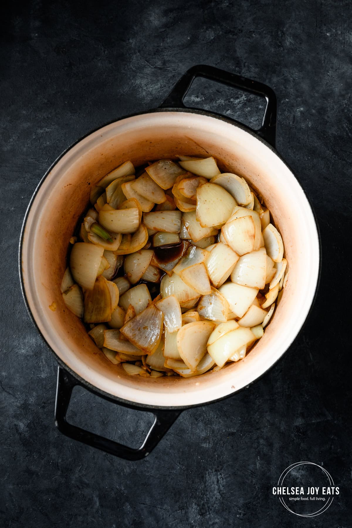 Onions and garlic sautéing in a Dutch oven.
