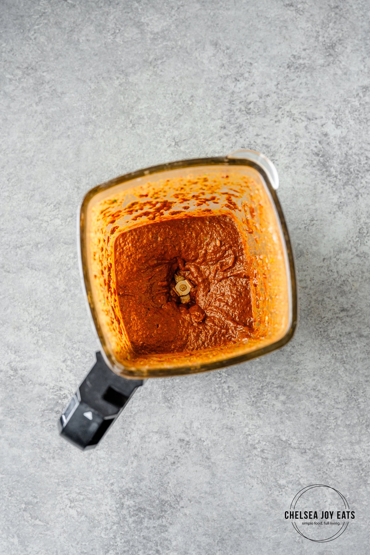 Carne asada marinade blended in the carafe of a blender.