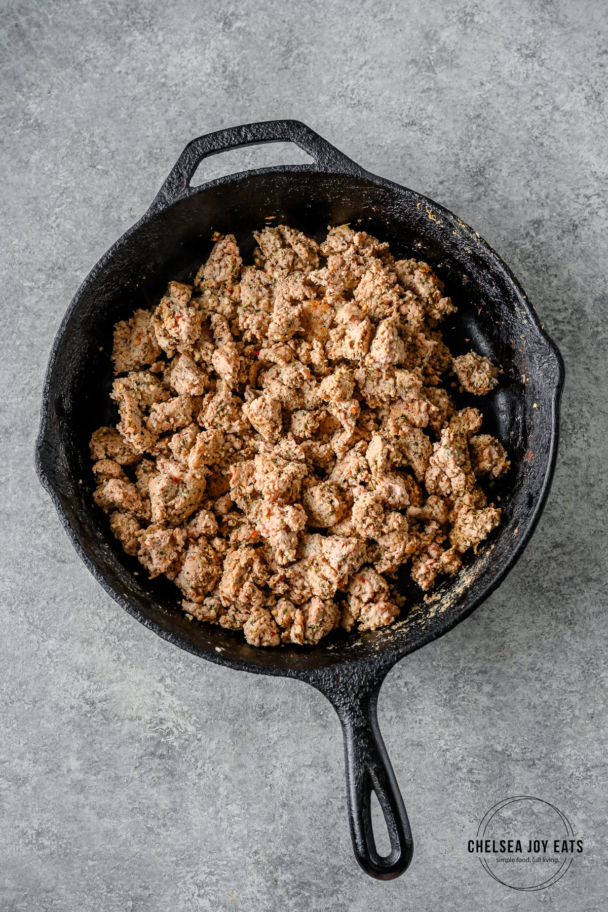 Ground turkey cooked in a cast iron skillet.