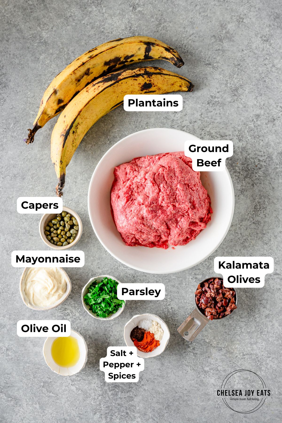 Ingredients for plantain ground beef bowls with olives and capers in individual dishes with text labels for each ingredient.