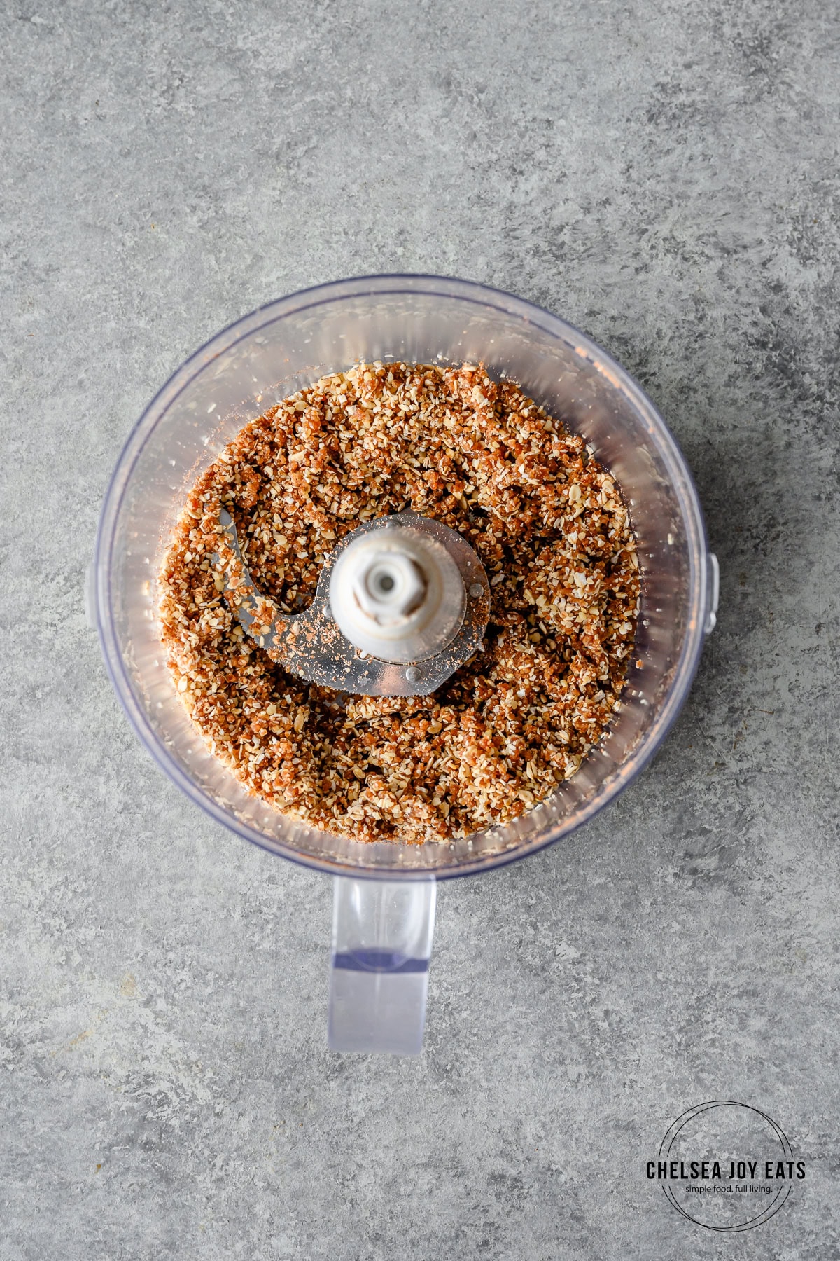 Date, oat, and walnut mixture blitzed in the bowl of a food processor.
