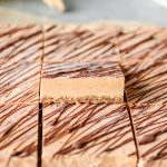 Rows of frozen no bake banana ice cream bars with one propped up to show its texture.