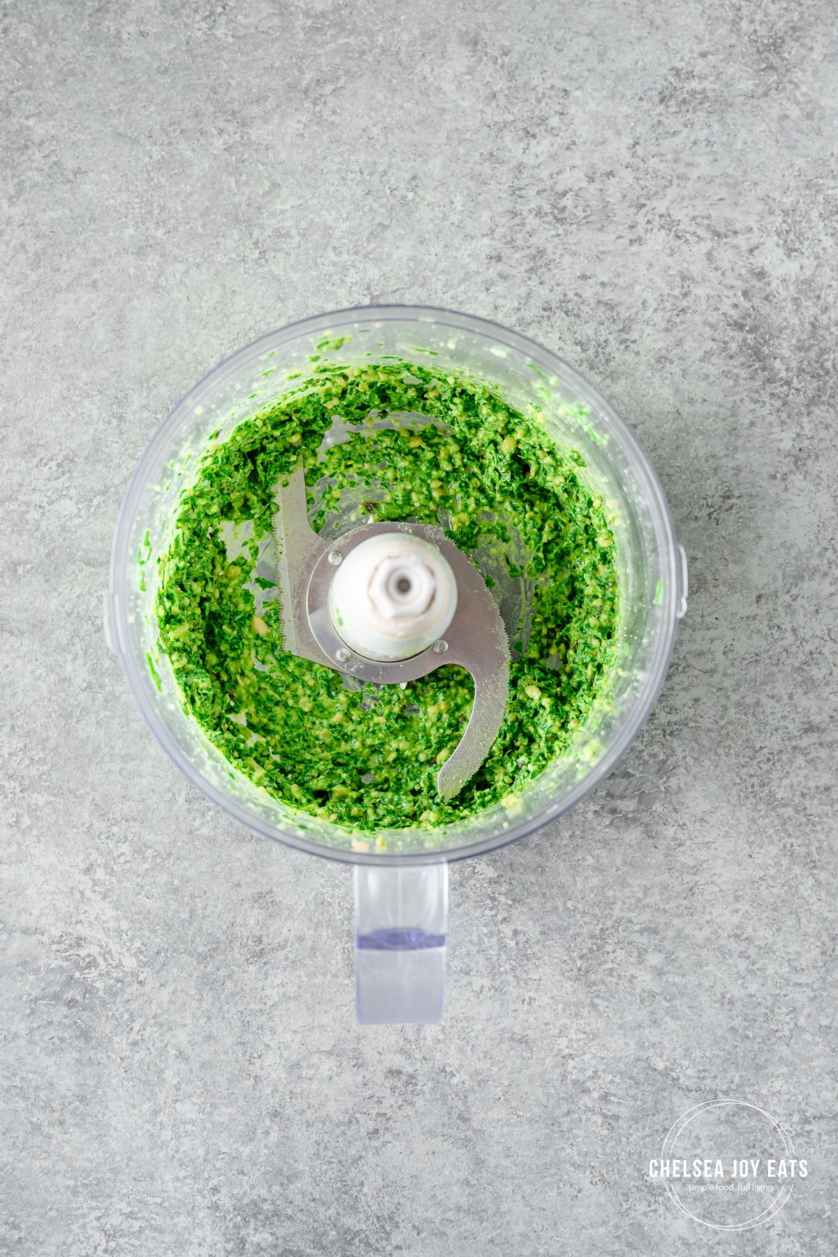 Fresh dairy free pesto in the bowl of a food processor.