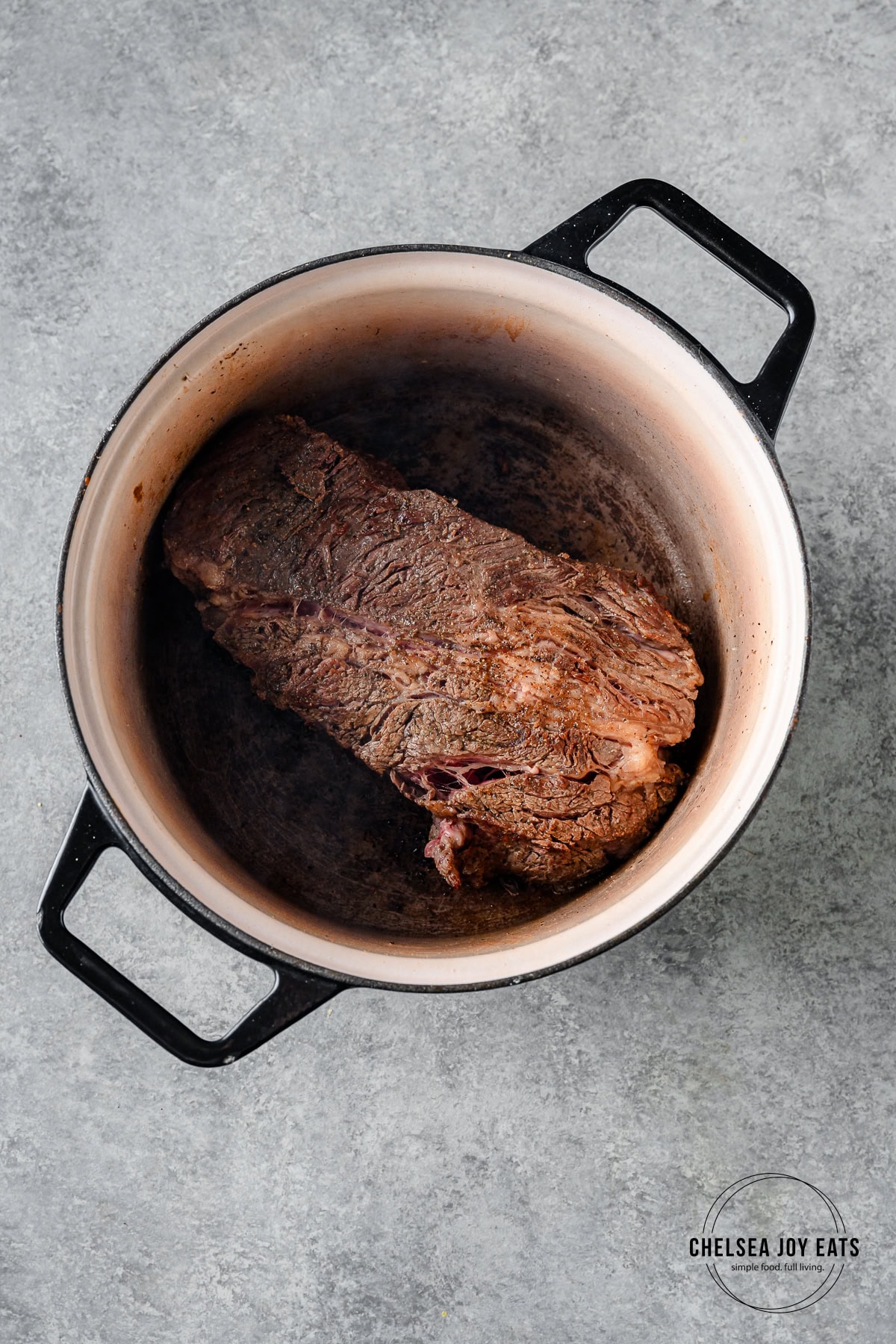Chuck roast searing in a dutch oven.