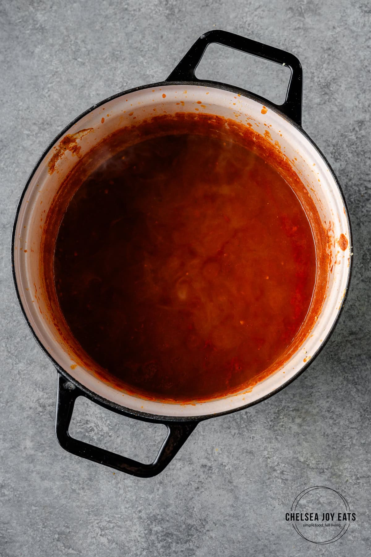 Unblended curry sauce simmering in a Dutch oven.